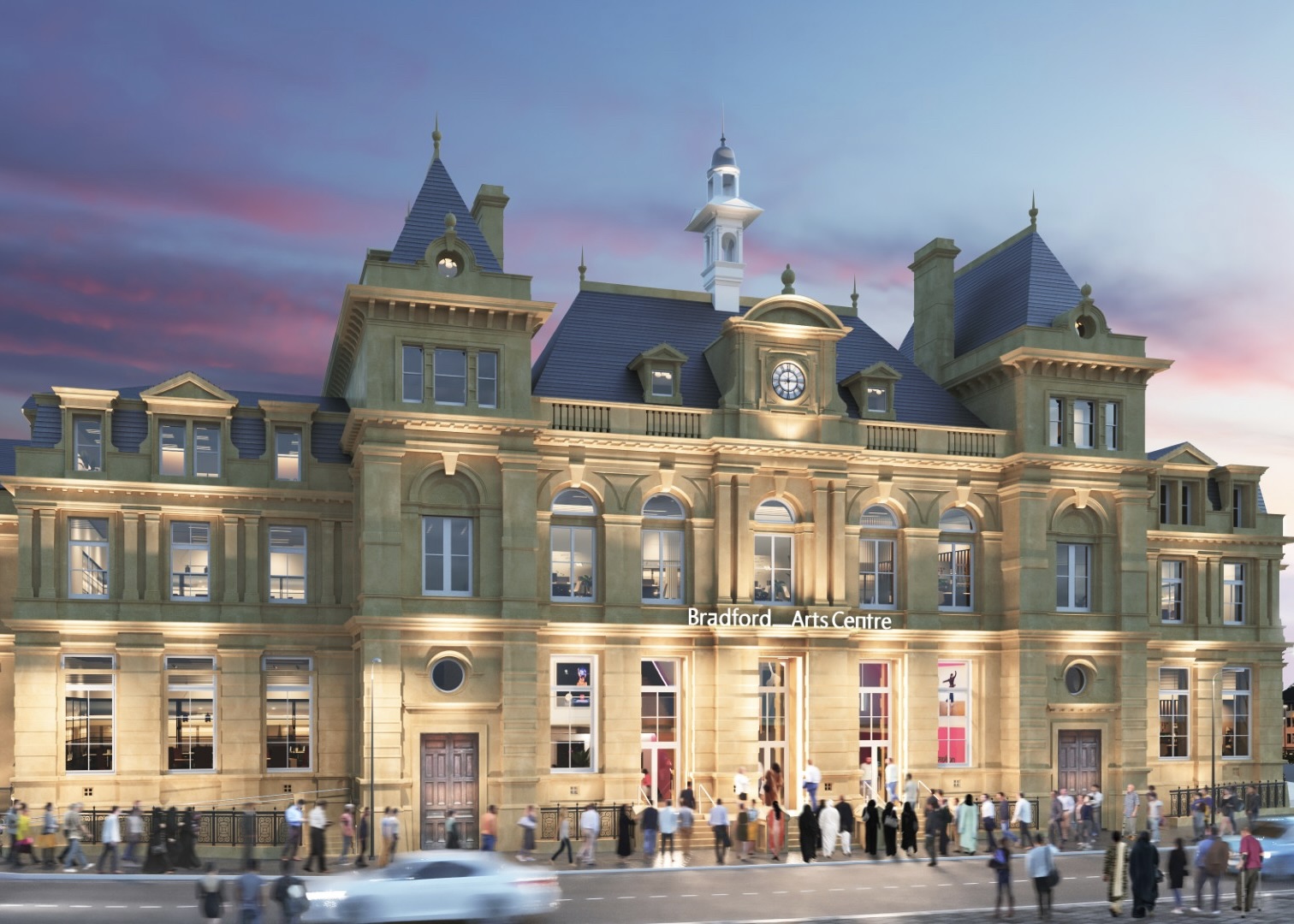 Bradford Arts Centre lit up against a pink and blue evening sky.